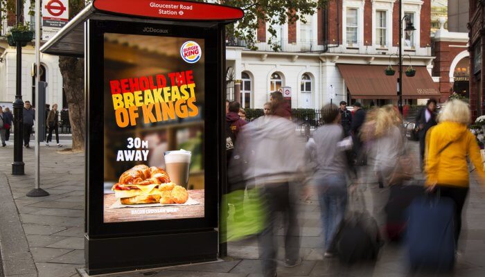 Image showing a DOOH Advertising example on a digital screen at Bus Shelter