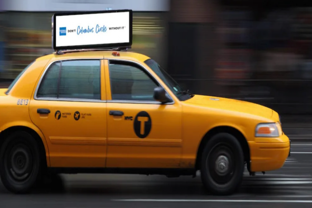 transit ad in the headrest of a taxi