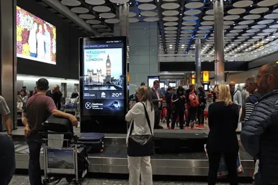 night scene of DOOH billboards in the city
