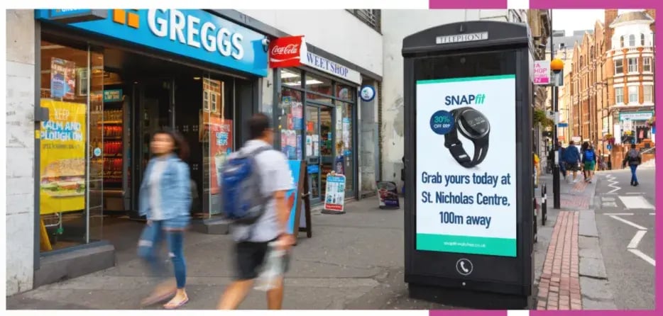 A busy high-street featuring an example of an OOH advertisement